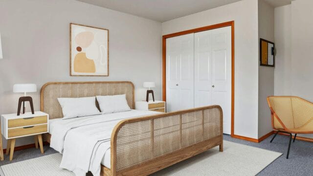 A bright, neutral toned bedroom with vibrant orange base board painted trim.