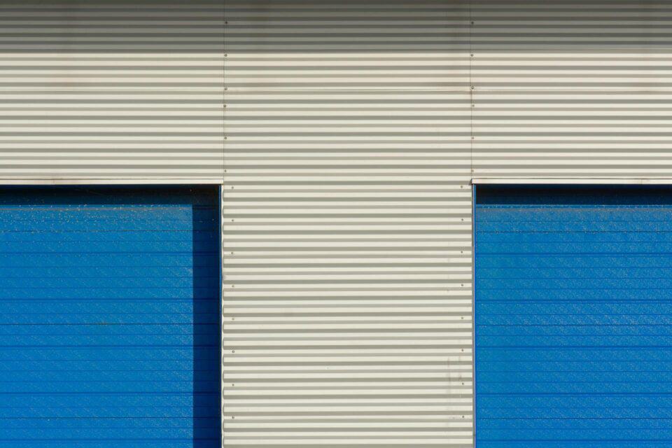 white metal warehouse walls with vibrant blue doors